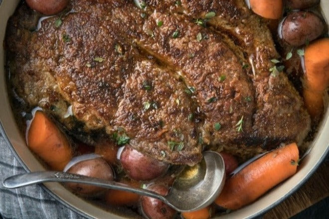 Chuck Roast in a pot with carrots and potatoes 