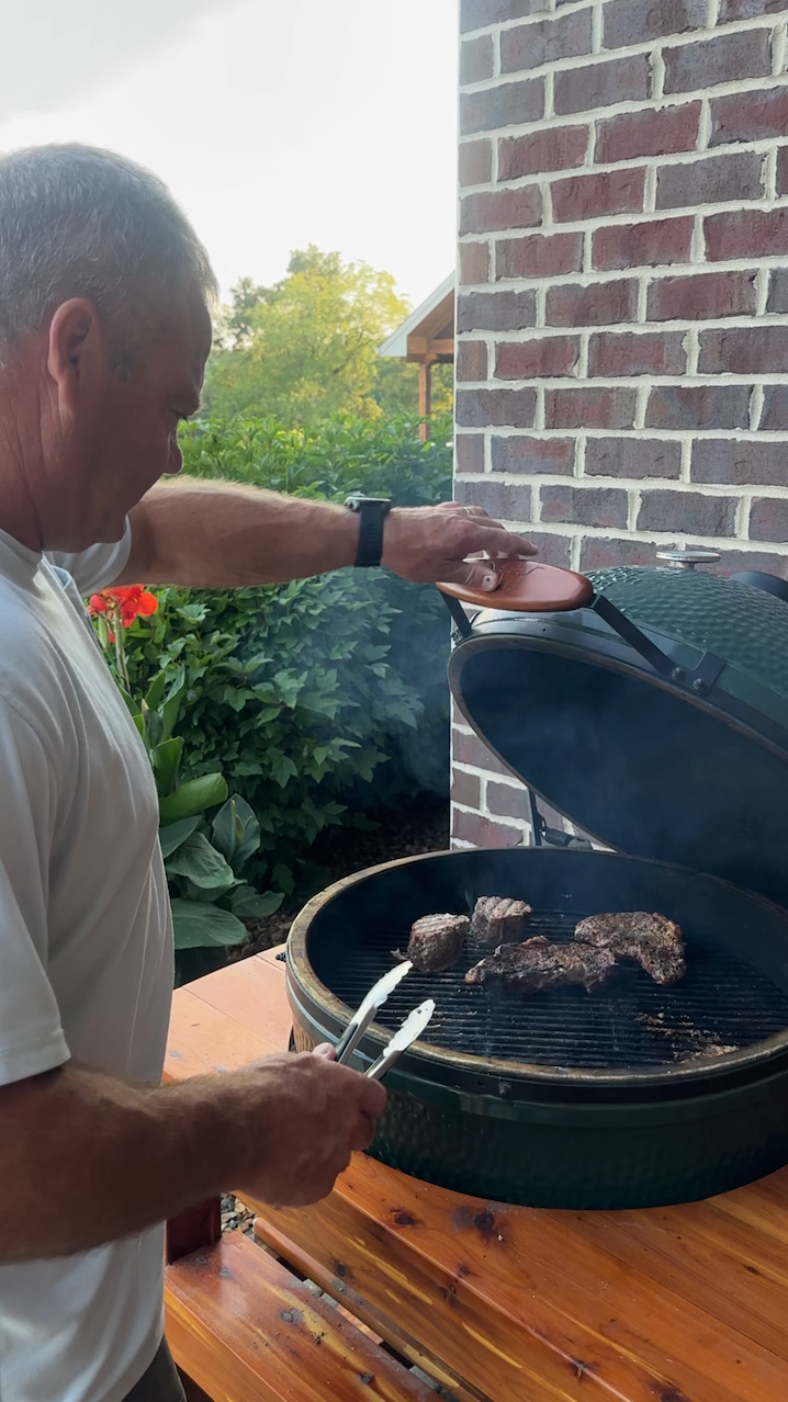 man grilling on green egg grill 